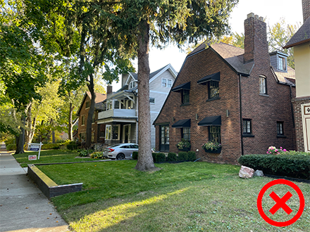 An incorrect example of grading shown by a retaining wall interfering with the slope of the front lawn. 